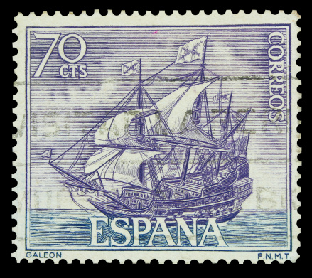 An old and used postage stamp of a Spanish galleon