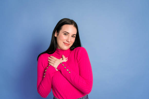 istock Smiling woman with hands on chest 1460761258