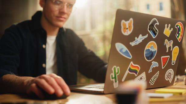 istock Focused Male Software Engineer Codding on Laptop Computer and Working With Inspiration in Modern Loft Flat. Man Creating New Mobile Application. Freelancer Doing Remote Work. 1460766401
