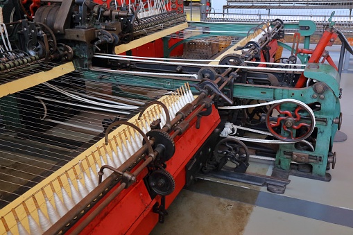 Textile factory machine. Old loom machine. Historic textile industry.
