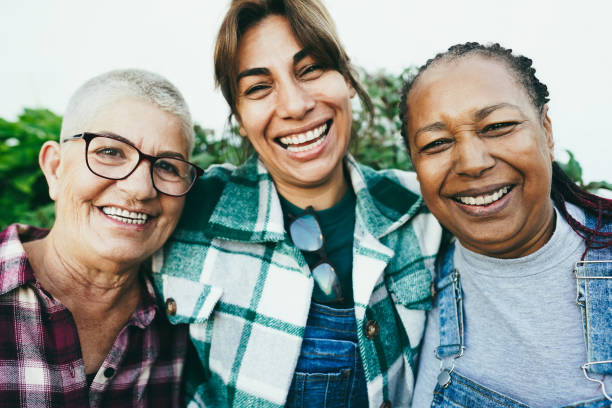 Multiracial senior women having fun together outdoor - Focus on african female face stock photo