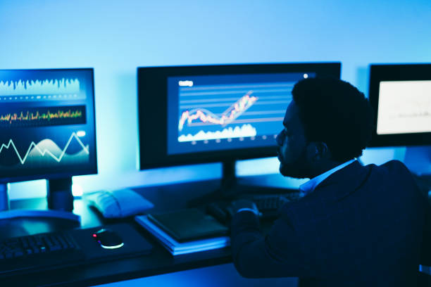 istock African trader working inside office at night time - Main focus on man ear 1460771169