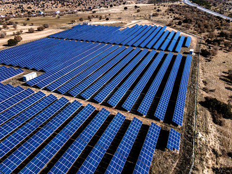 Flying over solar panels power plant from above.