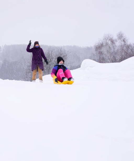 istock Kids having fun in a snow. 1460773383