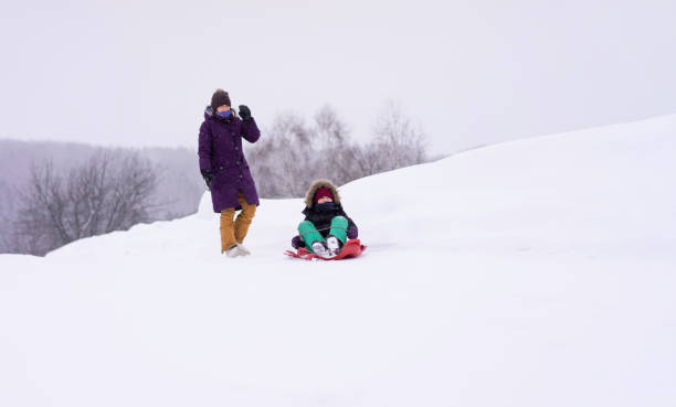 istock Kids having fun in a snow. 1460773397