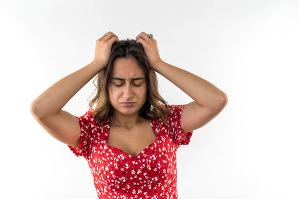 istock Beautiful young brunette suffering from headache on white isolated background. 1460775460