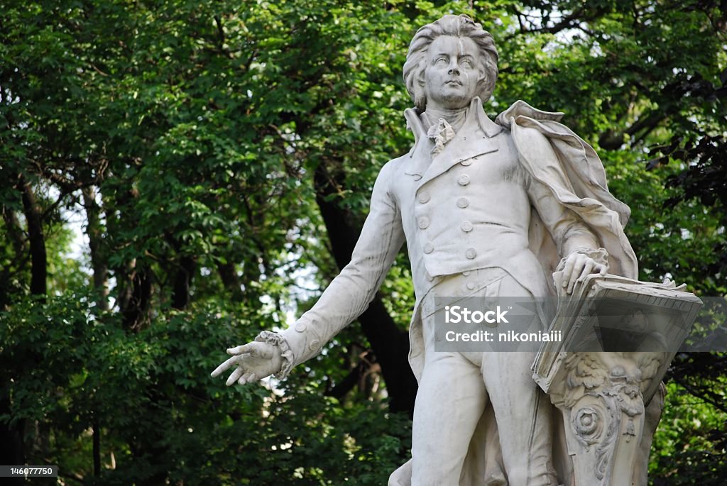 Statue of Mozart in front of trees Mozart statue in the burggarten Vienna Wolfgang Amadeus Mozart Stock Photo