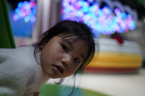 Cute little girl having fun in amusement park
