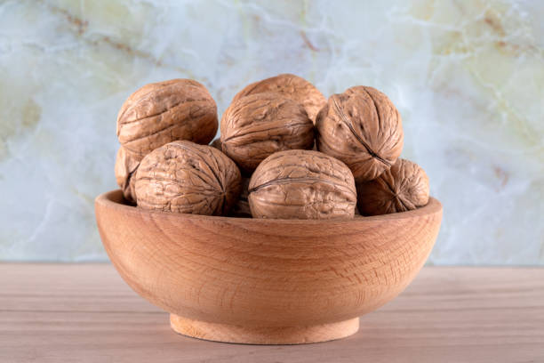 Whole walnuts in shell in bowl,closeup