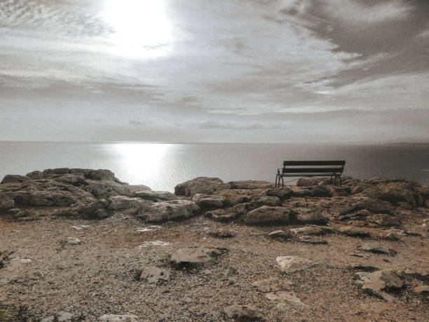 An empty bench on a cliff. Cape Greco sea view point near Ayia Napa. Travel, relaxation and tranquility. An empty bench on a cliff. Cape Greco sea view point near Ayia Napa. The concept of travel, relaxation and tranquility. Summer sunny landscape. Cavo Greco, Cyprus, Mediterranean Sea coast. stone bench top view stock pictures, royalty-free photos & images