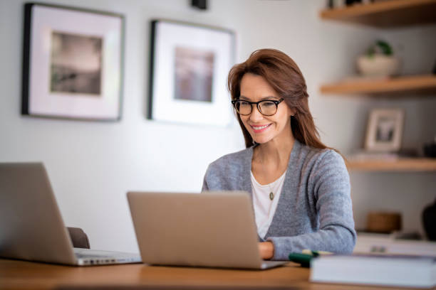 istock Attractive middle aged businesswoman sitting at home and using laptop for work 1460781173