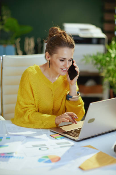 istock business owner woman talking on phone and working with documents 1460783115