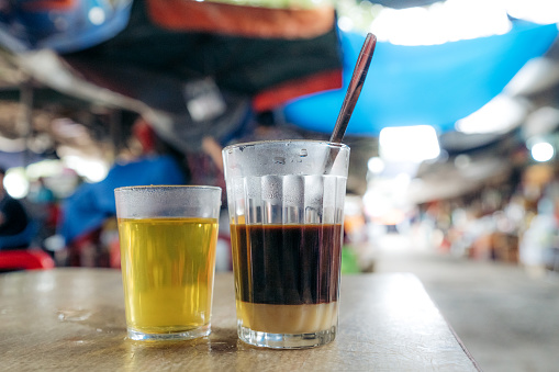 vietnamese coffee and hot tea at a local market\nHue, Vietnam