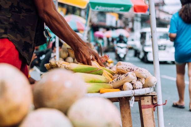 istock market stand with corn on a sidewalk in Manila, Philippines 1460783236