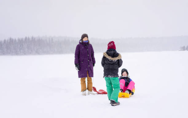 istock Kids having fun in a snow. 1460783730
