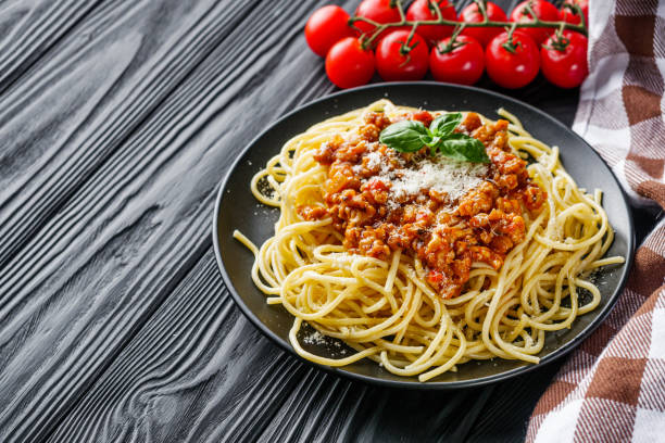 istock delicious Bolognese pasta on a black plate 1460785473