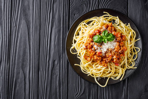 istock delicious Bolognese pasta on a black plate 1460785518