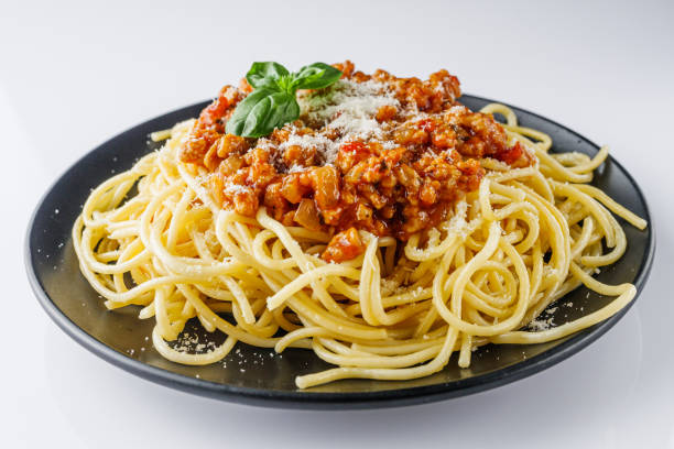 istock delicious Bolognese pasta on a black plate 1460785543