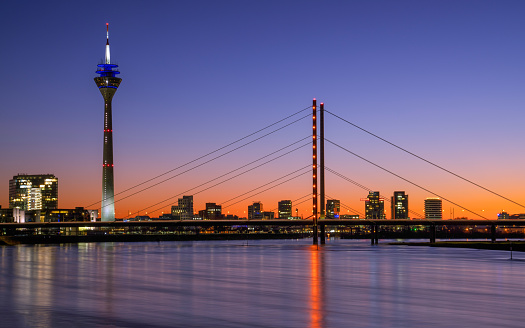 Colorful sunset on the Rhine river with the cityscape of Dusseldorf in the background, Germany