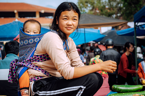 Vietnamese woman with baby at the markt\nBac Ha hosts the biggest fair near the mountainous highlands and the Chinese border\nBac Ha, northern Vietnam