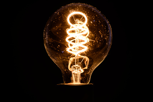 Filament LED light bulb with a spiral led shape studio shot isolated on a black background