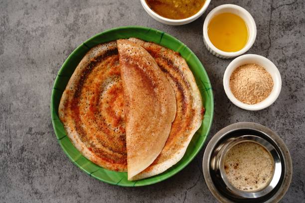 South Indian vegetarian breakfast South Indian vegetarian breakfast idli karam podi dosa sambar chutney powder ghee and filter coffee Upma stock pictures, royalty-free photos & images