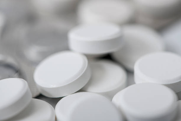 Two pain pills on a light table
