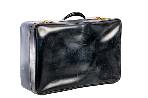 Old fashioned leather suitcase for traveling studio shot isolated on a white background.
