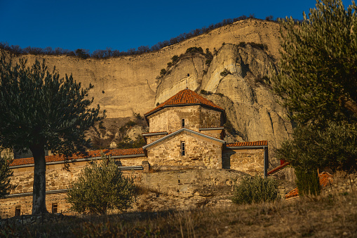 Shio Mgvime monastery at sunset light with mountain on background. Mtskheta, Georgia