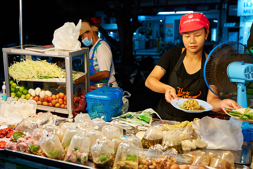 Night Food Market. Portrait of a food seller. Koh Samui, Thailand - 09.15.2022