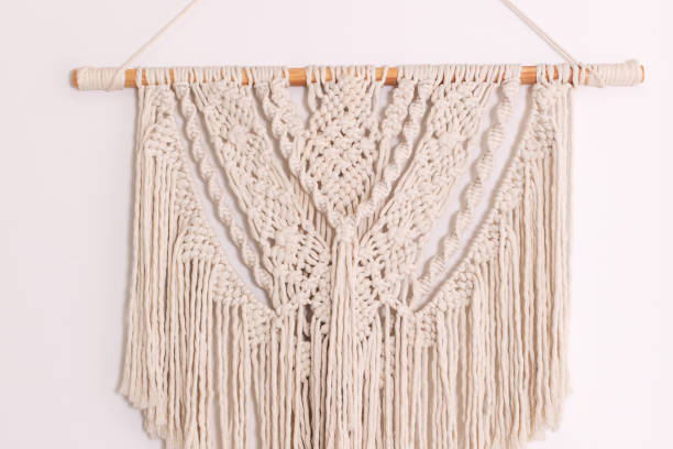istock Wall panel in style of Boho made of cotton threads using the macrame technique for home decor and wedding decoration. Cozy Home decor concept. White Macrame in living room with boho interior design 1460791930