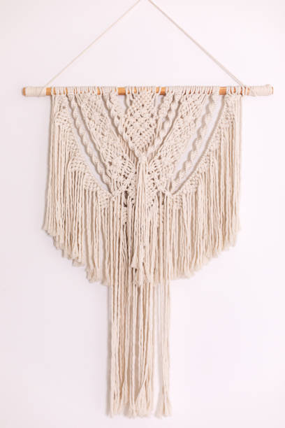 istock Wall panel in style of Boho made of cotton threads using the macrame technique for home decor and wedding decoration. Cozy Home decor concept. White Macrame in living room with boho interior design 1460791954