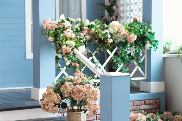 istock Spring design home with plants and bloom flowers hydrangea in pot on steps. House entrance staircase at home decorated for easter. Wooden porch of house with different flowers. Terrace of summer house 1460792439
