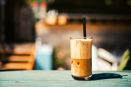 Summer, vacation and iced coffee frappe at the beach