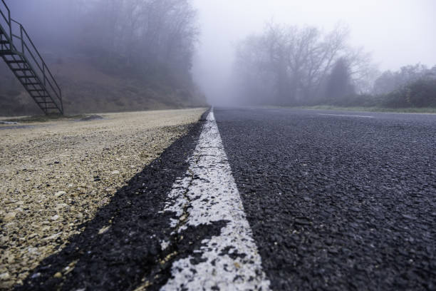 istock Mountain road with fog 1460793060