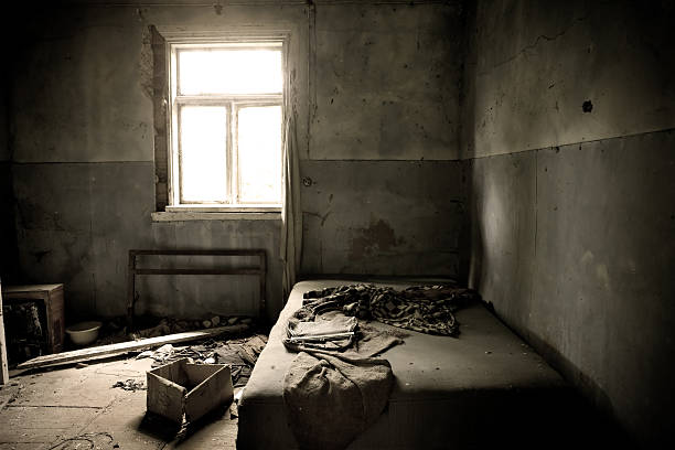 A dark moldy old abandoned bedroom stock photo