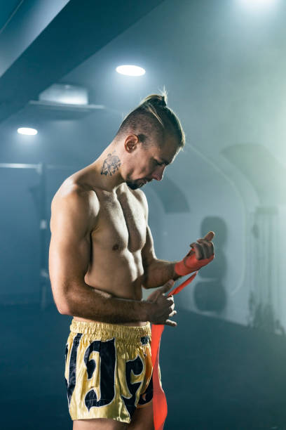 istock Muay Thai boxer preparing bandages for training. 1460796731