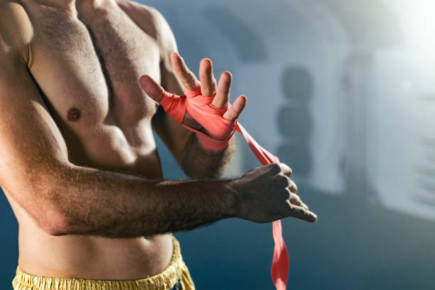 istock Close up of Muay Thai boxer preparing bandages for training. 1460796900