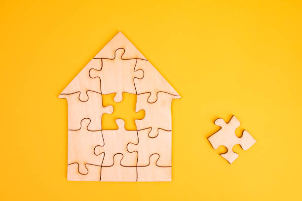 istock Puzzle house with a missing piece. The acquisition or construction comfortable dream home. Mortgage loan purchase real estate. Arrangement premises repair. Availability and cheapness. Finish building 1460799052