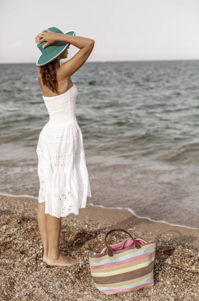 istock Woman relaxing at the seaside. 1460799321