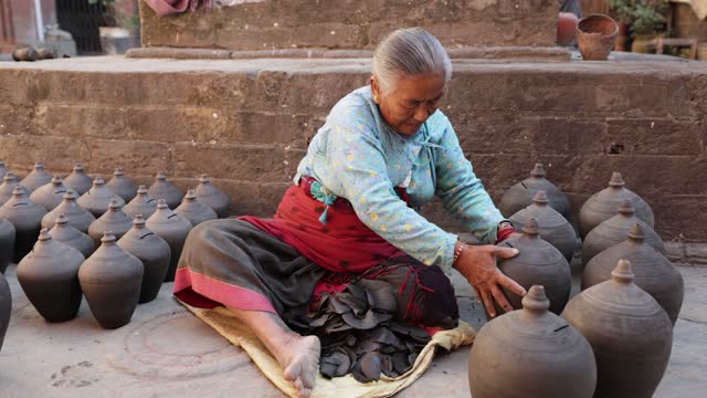 Nepali woman working on the pottery square in Bhaktapur