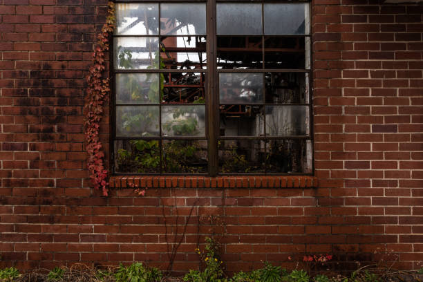istock Side of crumbling red brick building left to rot 1460800713
