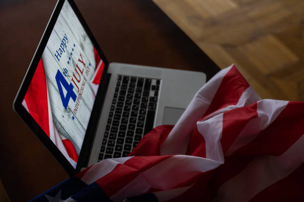 istock 4th of July American Independence Day USA flags decorations with computer 1460801691