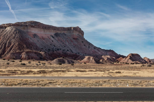 istock Decaying canyon wall on roadside with blue sky 1460801768