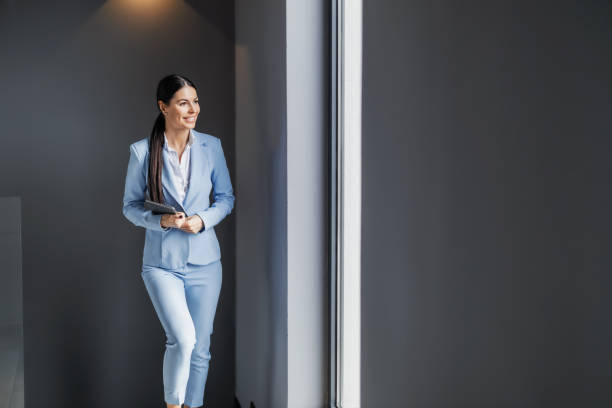istock Smiling businesswoman standing in modern office 1460803865