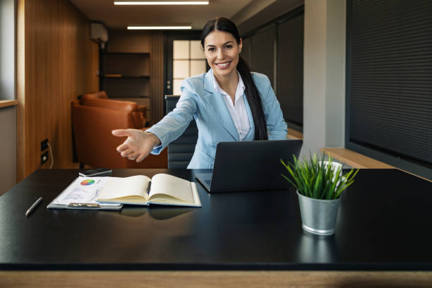 istock Young business woman inviting to come with hand 1460804702