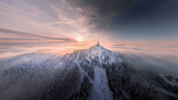 Jested tower mountain hill with snow mist and fog at golden hour
