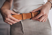 Woman wearing modern leather belt