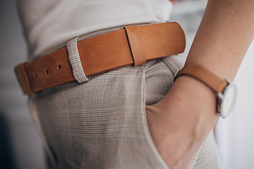 Unrecognizable elegant woman wearing modern leather belt.