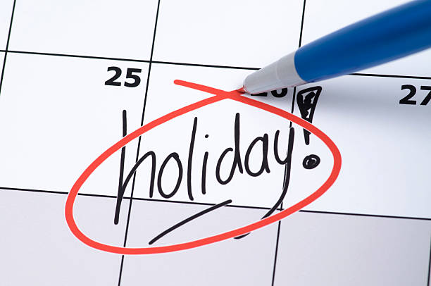 Calendar with a holiday date circled in red ink It is finally holiday! Marked and written holiday in a calendar. holiday calendar stock pictures, royalty-free photos & images